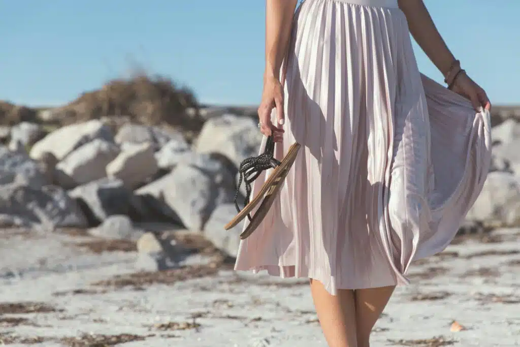 a woman in a dress holding a flip flop