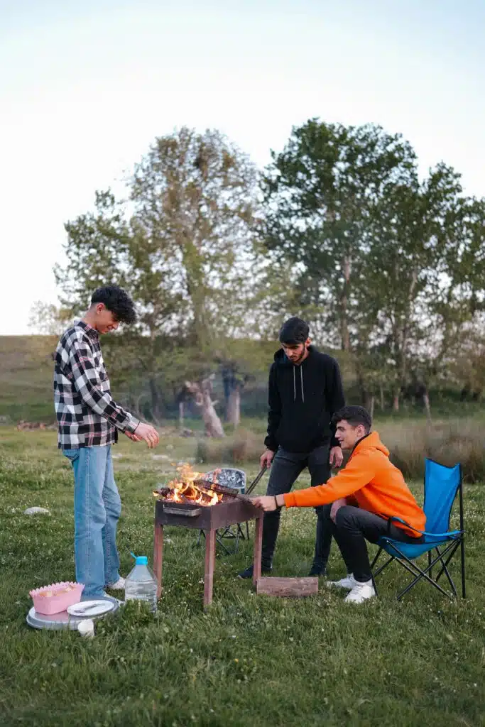 a group of men grilling on a fire